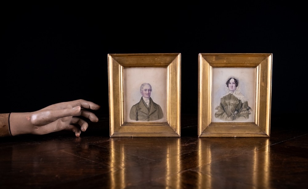 A pair of early 19th-century watercolour portrait paintings featuring a gentleman and a lady set within thick moulded giltwood frames. View III