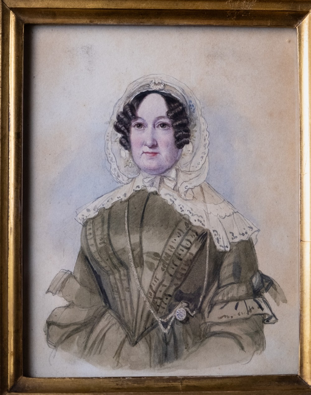 A pair of early 19th-century watercolour portrait paintings featuring a gentleman and a lady set within thick moulded giltwood frames. View IV