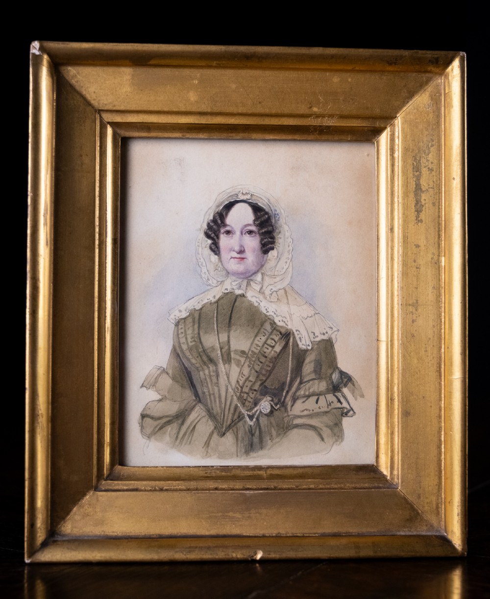 A pair of early 19th-century watercolour portrait paintings featuring a gentleman and a lady set within thick moulded giltwood frames. View VI