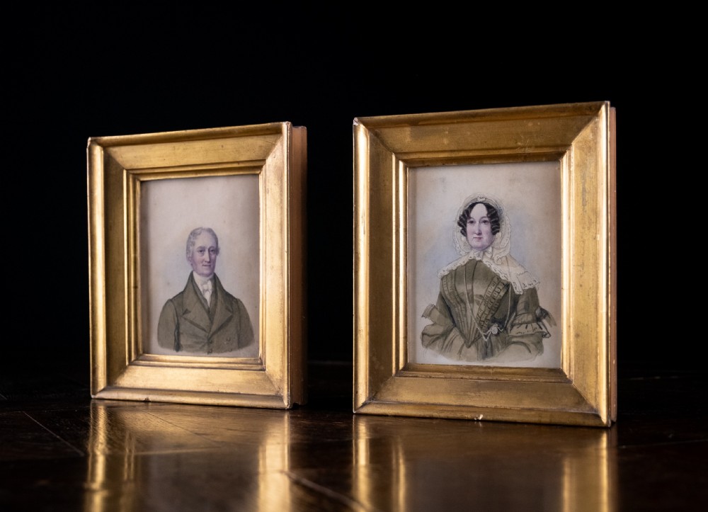A pair of early 19th-century watercolour portrait paintings featuring a gentleman and a lady set within thick moulded giltwood frames. View IX
