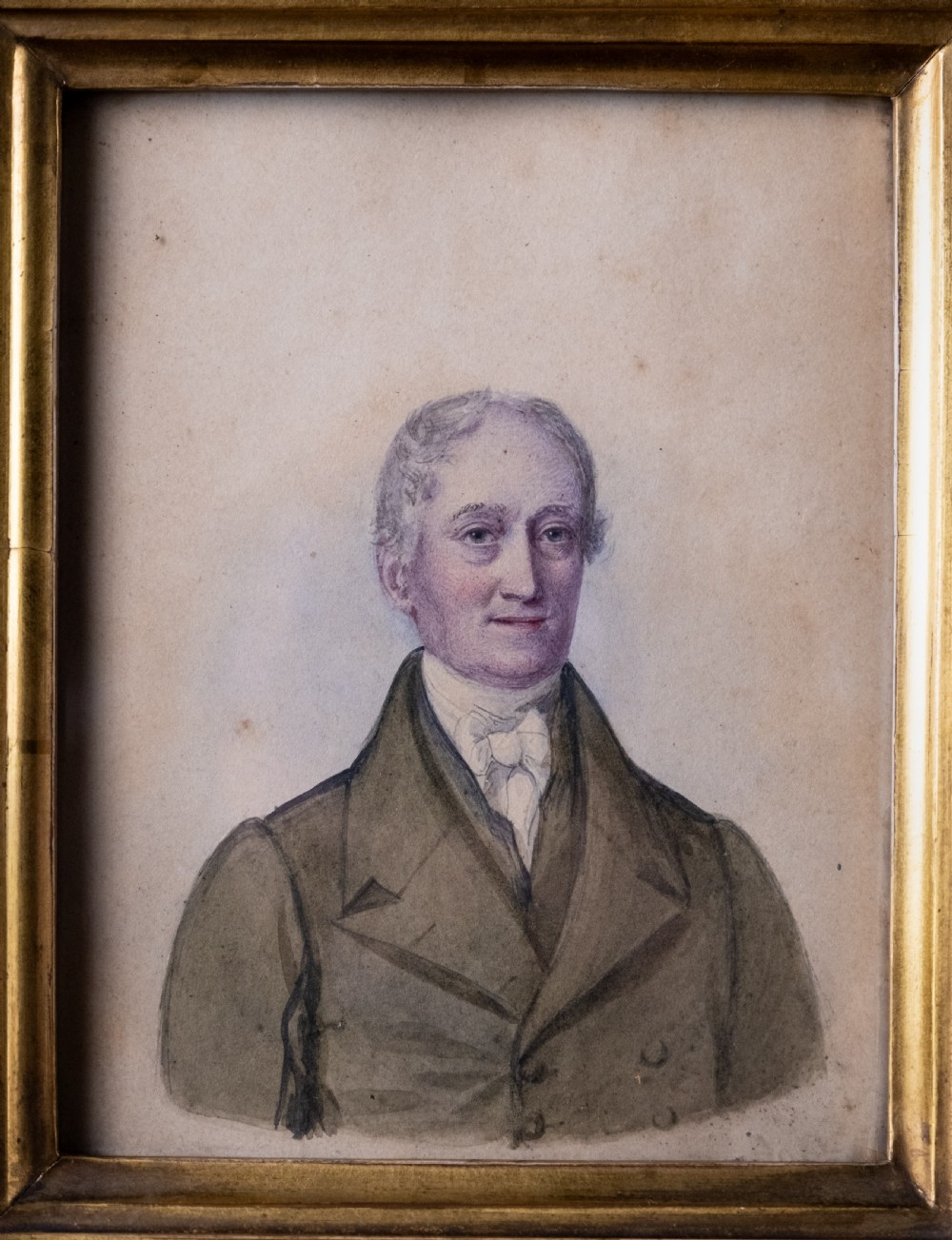 A pair of early 19th-century watercolour portrait paintings featuring a gentleman and a lady set within thick moulded giltwood frames. View XI