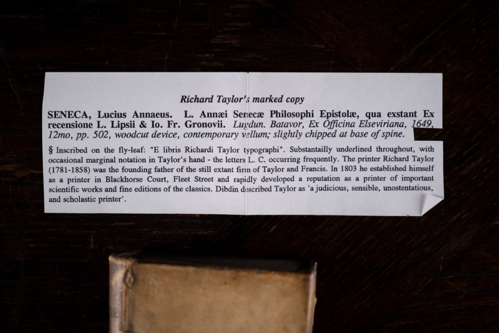 A 17th-century vellum-bound book standing upright with handwritten Latin text on the spine. View XI