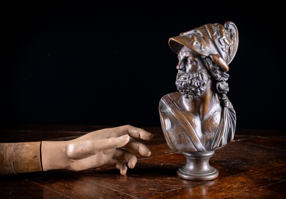 A patinated dark brown French bronze bust depicting the classical figure of Ajax wearing a detailed helmet, set upon a turned circular pedestal. View XI