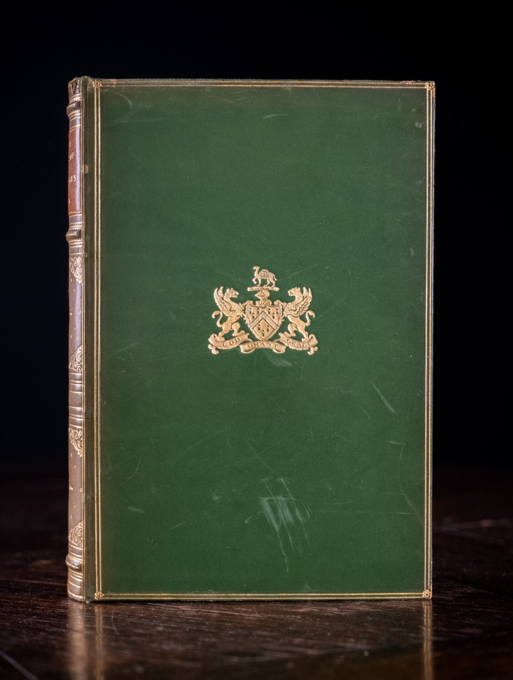 An upright antique book titled Myths and Legends of the Middle Ages with a brown leather spine featuring gilt tooling and green cloth covers. View III