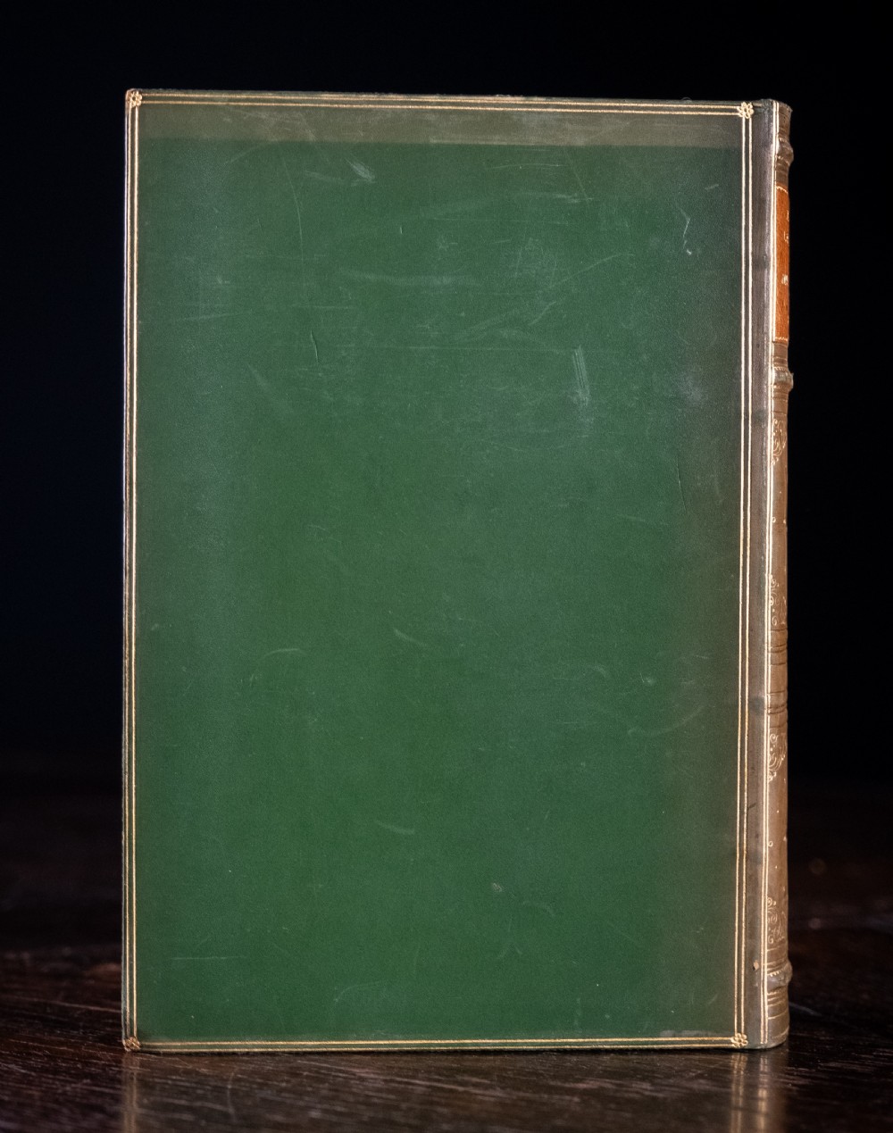 An upright antique book titled Myths and Legends of the Middle Ages with a brown leather spine featuring gilt tooling and green cloth covers. View IV