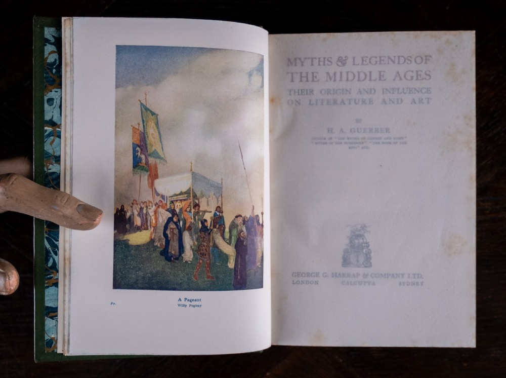 An upright antique book titled Myths and Legends of the Middle Ages with a brown leather spine featuring gilt tooling and green cloth covers. View IX