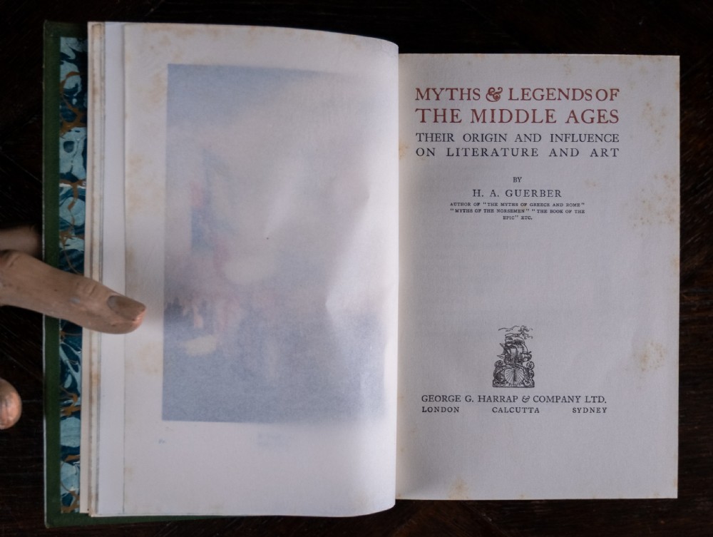 An upright antique book titled Myths and Legends of the Middle Ages with a brown leather spine featuring gilt tooling and green cloth covers. View X