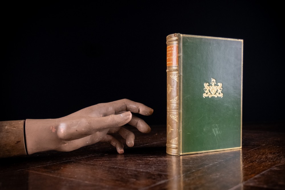 An upright antique book titled Myths and Legends of the Middle Ages with a brown leather spine featuring gilt tooling and green cloth covers. View XVI