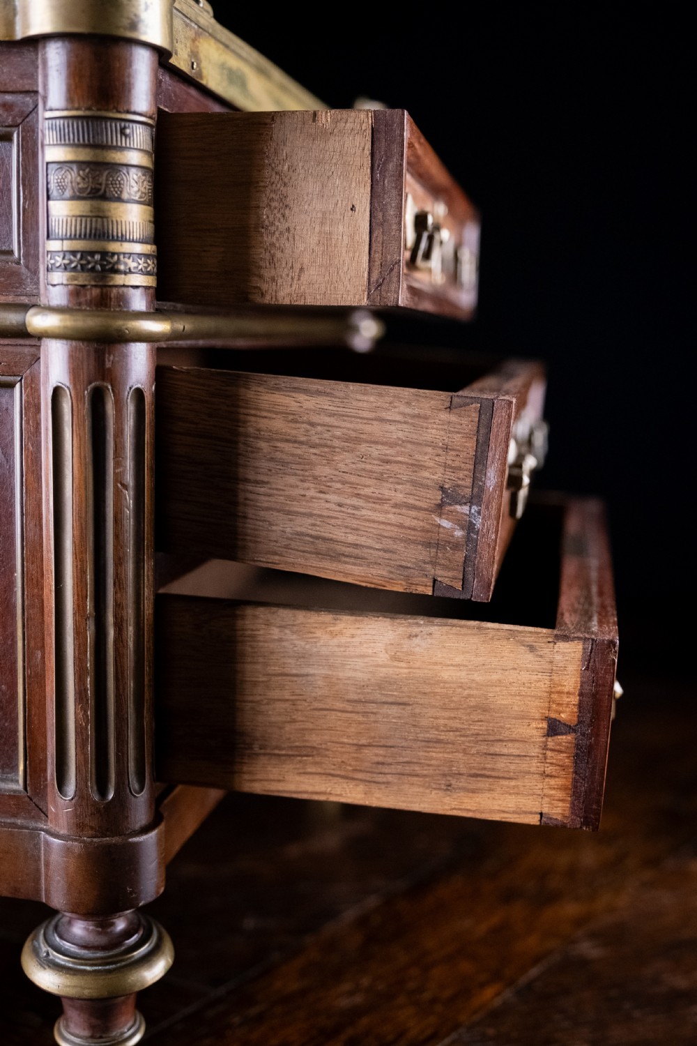 A miniature Louis XVI style mahogany three-drawer commode featuring brass mounts, fluted corner columns, and a gallery top inset with marble. View VII