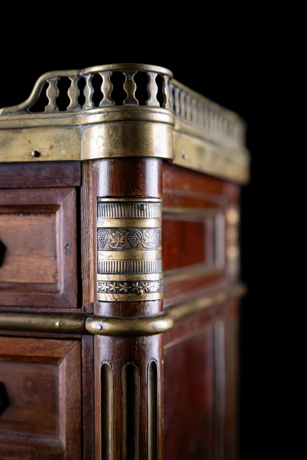 A miniature Louis XVI style mahogany three-drawer commode featuring brass mounts, fluted corner columns, and a gallery top inset with marble. View XI