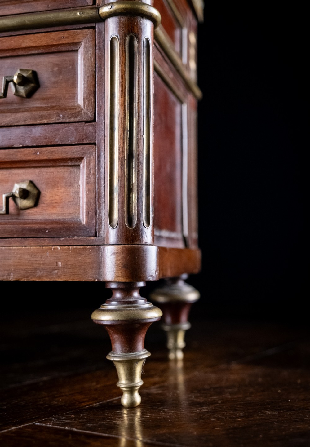 A miniature Louis XVI style mahogany three-drawer commode featuring brass mounts, fluted corner columns, and a gallery top inset with marble. View XII
