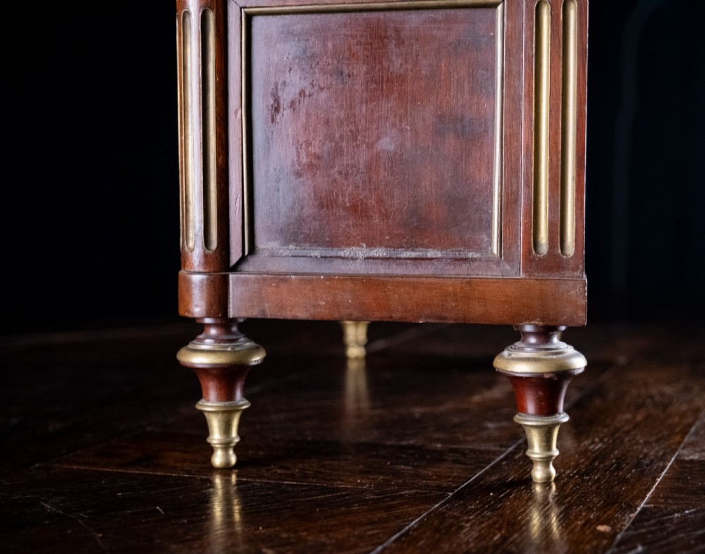 A miniature Louis XVI style mahogany three-drawer commode featuring brass mounts, fluted corner columns, and a gallery top inset with marble. View XV