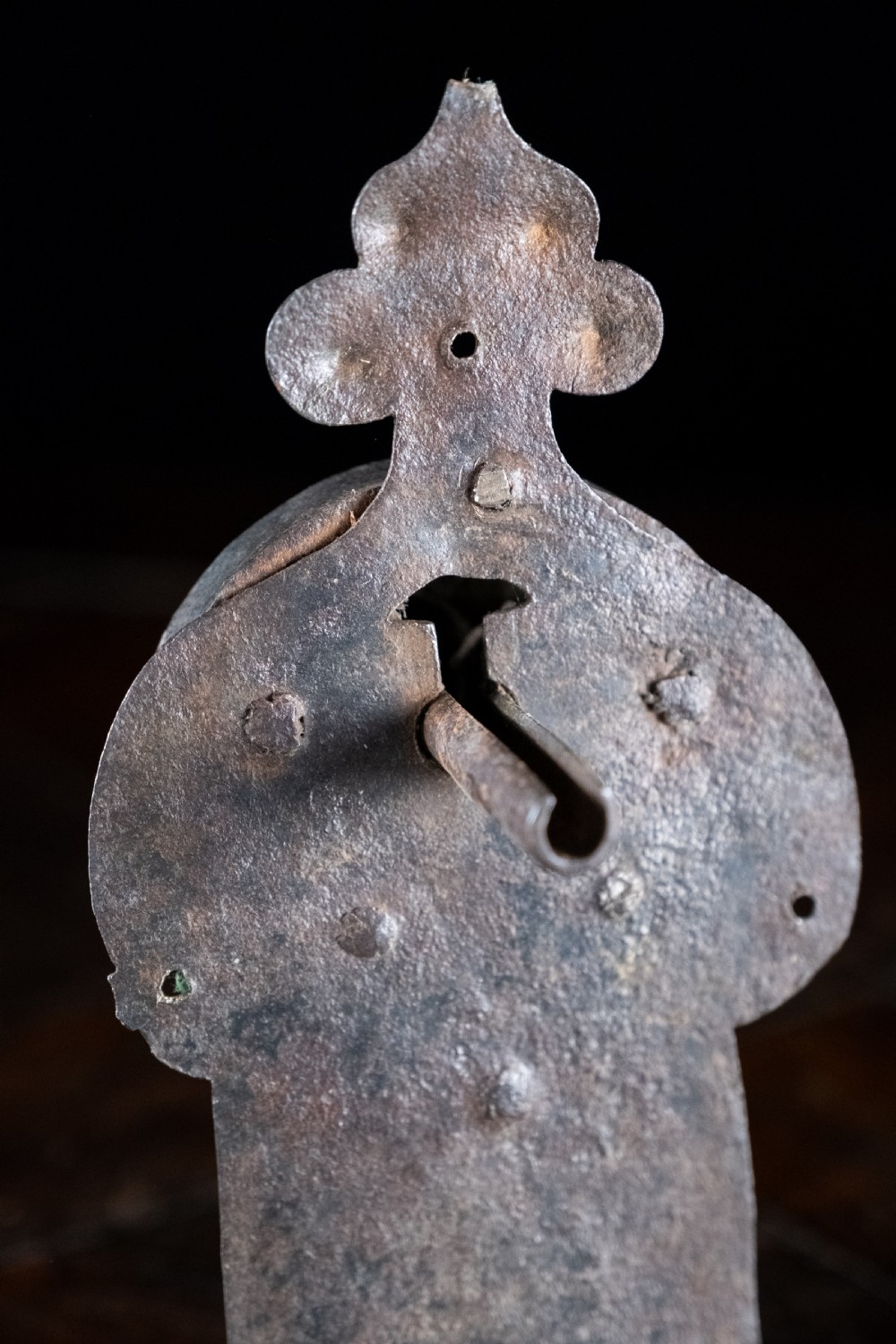 A hand-forged sixteenth-century wrought iron lock plate with a prominent key barrel and trefoil top finial. View II