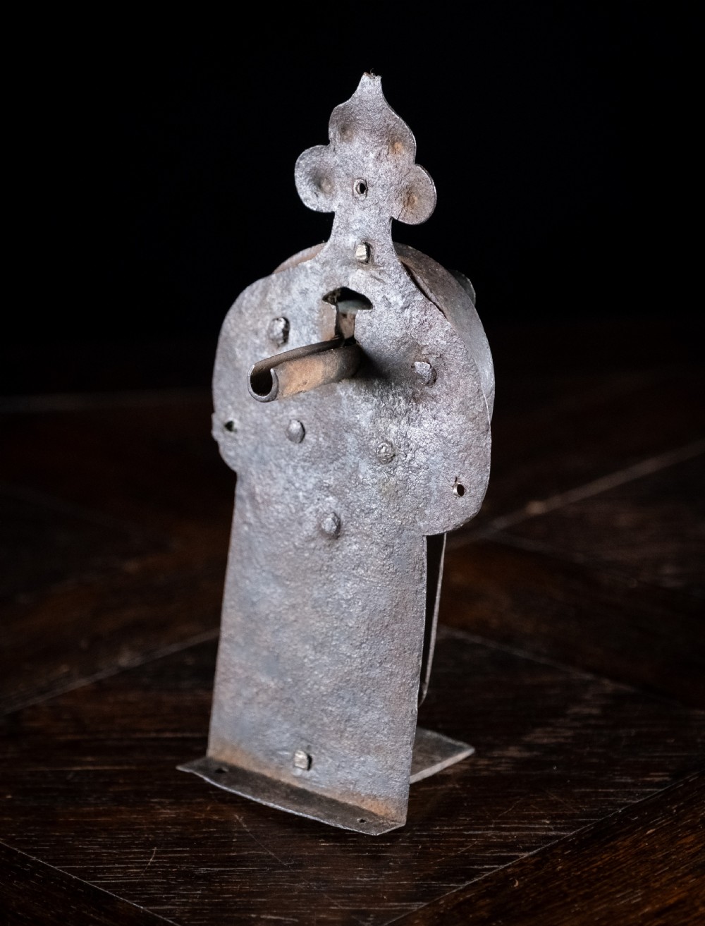 A hand-forged sixteenth-century wrought iron lock plate with a prominent key barrel and trefoil top finial. View IV
