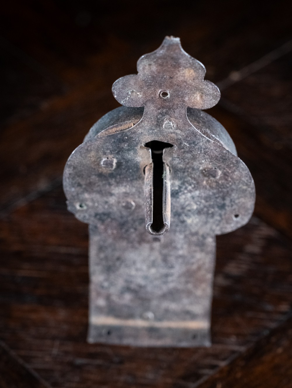 A hand-forged sixteenth-century wrought iron lock plate with a prominent key barrel and trefoil top finial. View V