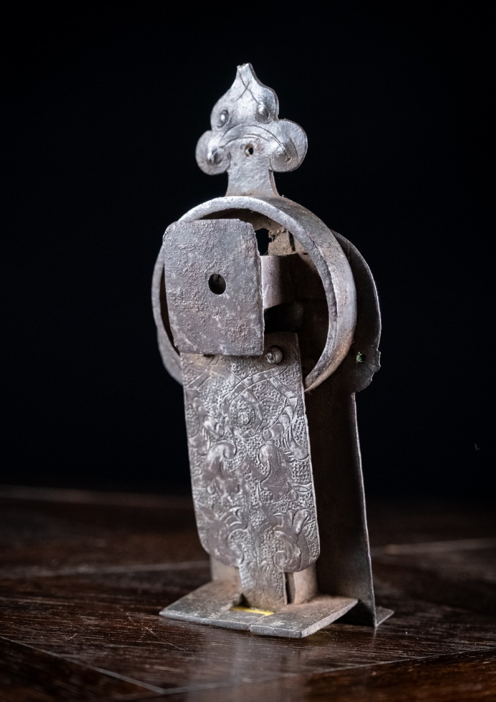 A hand-forged sixteenth-century wrought iron lock plate with a prominent key barrel and trefoil top finial. View VI