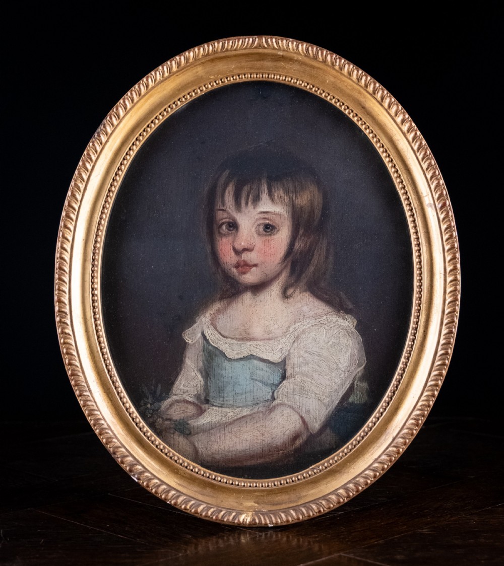 An 18th-century oval portrait painting depicting a young girl with brown hair wearing a blue and white dress within a gilded frame.