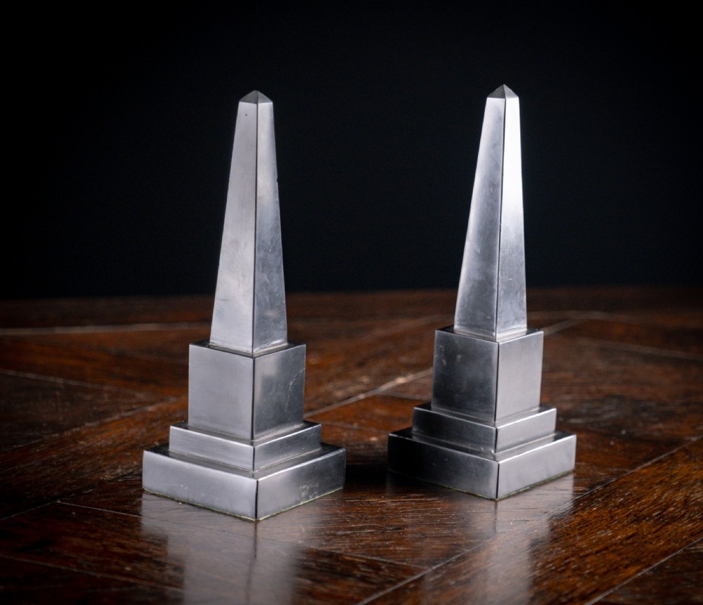 A pair of 19th-century black marble obelisks featuring tapered four-sided shafts set on stepped square plinth bases. View II