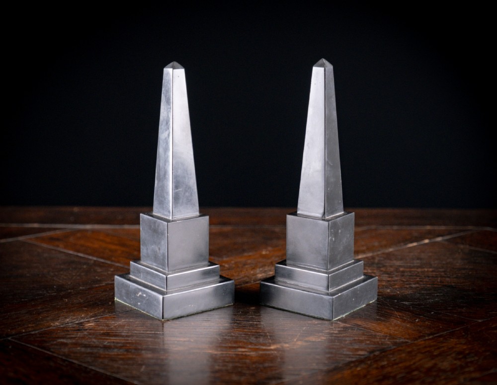 A pair of 19th-century black marble obelisks featuring tapered four-sided shafts set on stepped square plinth bases. View III