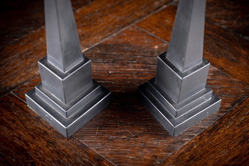 A pair of 19th-century black marble obelisks featuring tapered four-sided shafts set on stepped square plinth bases. View IV