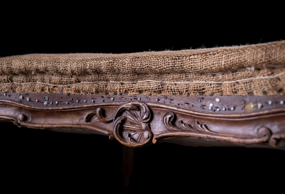 A low rectangular Louis XV style footstool featuring a carved beech frame, cabriole legs, shell motifs, and hessian upholstery. View VIII