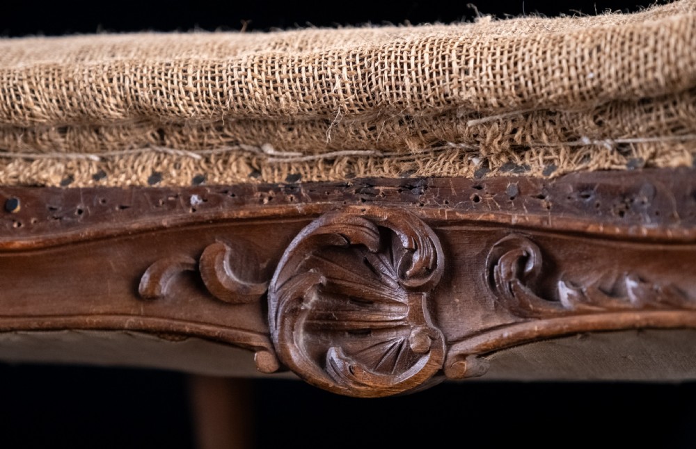 A low rectangular Louis XV style footstool featuring a carved beech frame, cabriole legs, shell motifs, and hessian upholstery. View IX