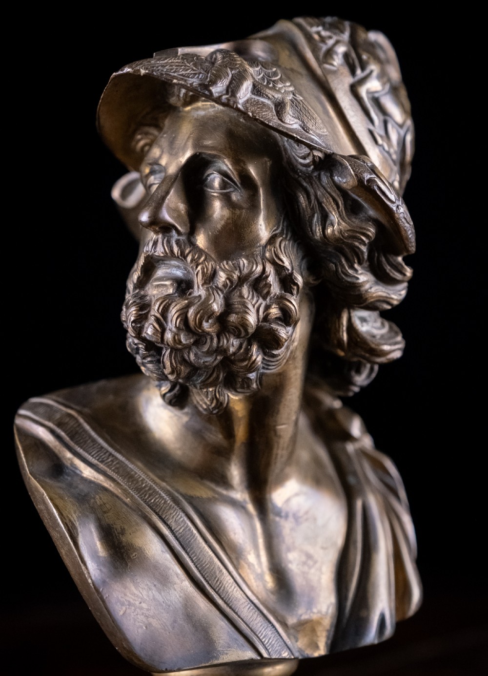 A nineteenth-century gilt bronze sculptural bust depicting the classical hero Ajax in profile, wearing an ornate helmet and mounted on a turned pedestal base. View II