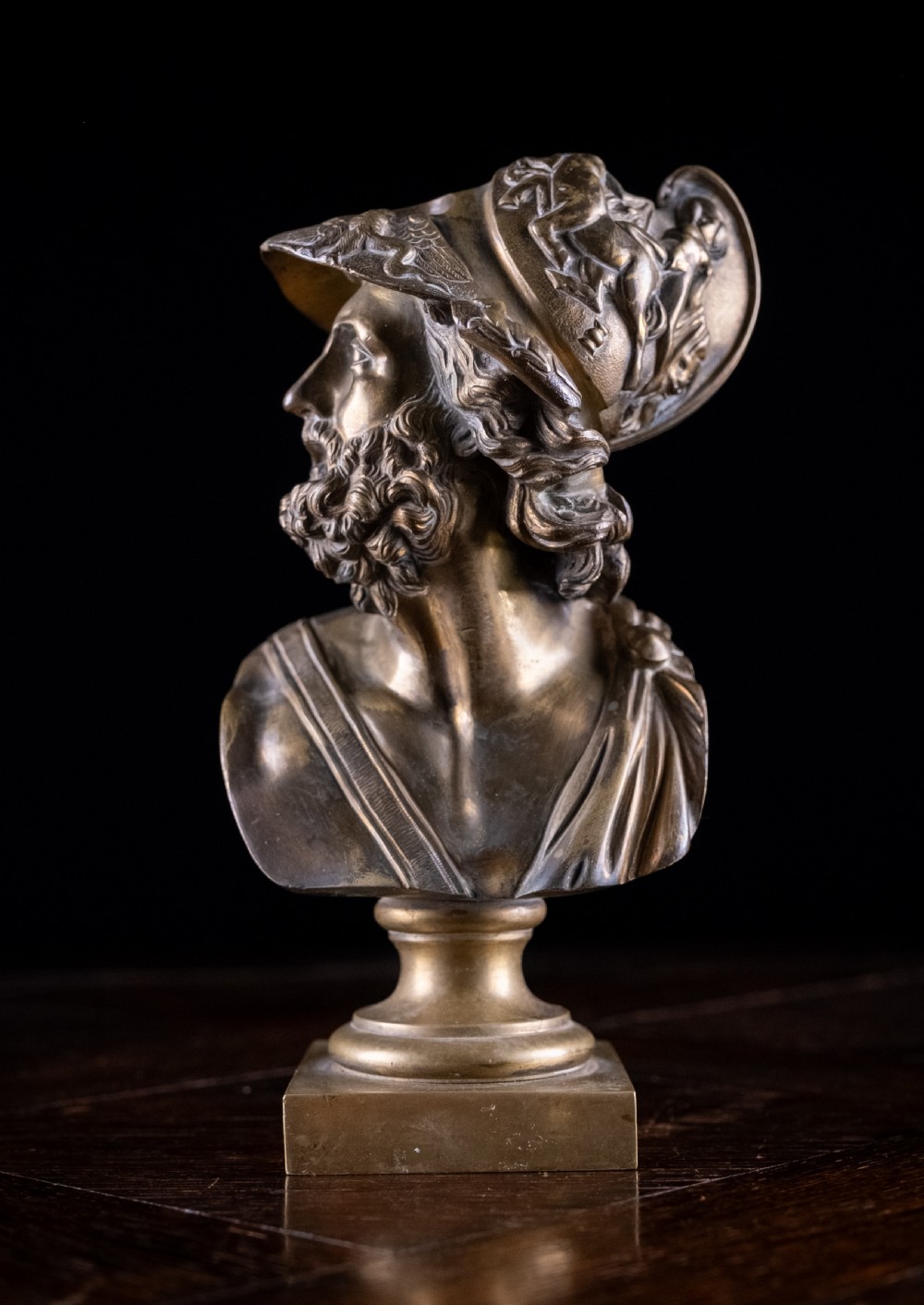 A nineteenth-century gilt bronze sculptural bust depicting the classical hero Ajax in profile, wearing an ornate helmet and mounted on a turned pedestal base.