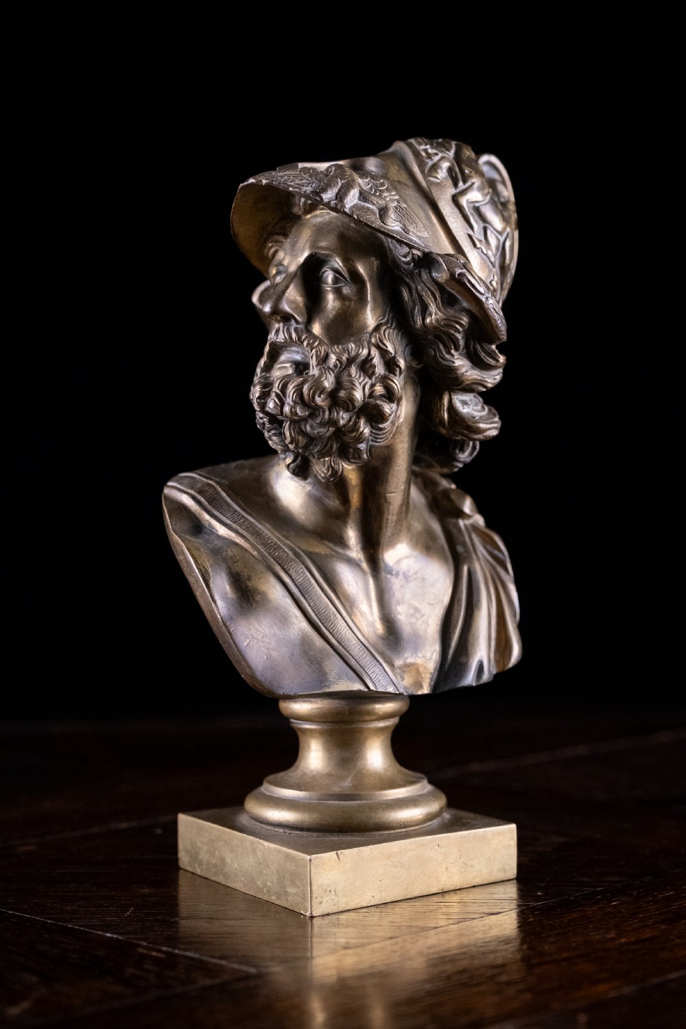 A nineteenth-century gilt bronze sculptural bust depicting the classical hero Ajax in profile, wearing an ornate helmet and mounted on a turned pedestal base. View III