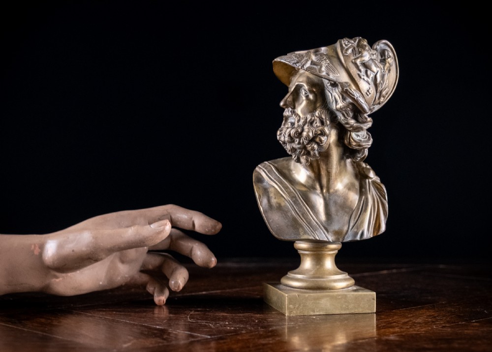 A nineteenth-century gilt bronze sculptural bust depicting the classical hero Ajax in profile, wearing an ornate helmet and mounted on a turned pedestal base. View XIV