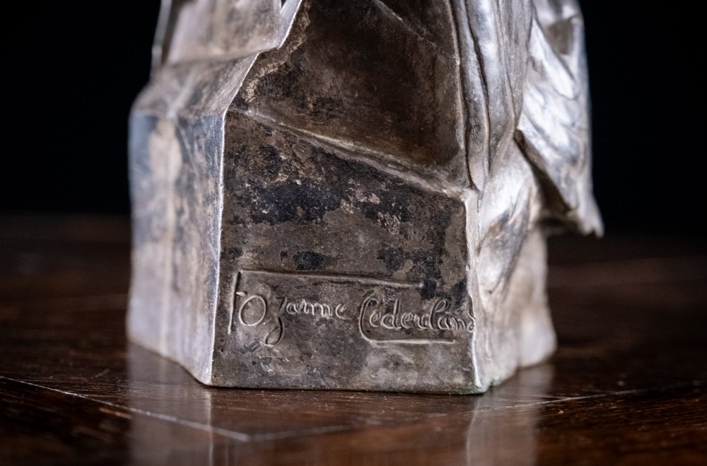 A dark nickel bronze sculpture depicting two stylised pigeons resting together on an integrated rectangular base. View IV