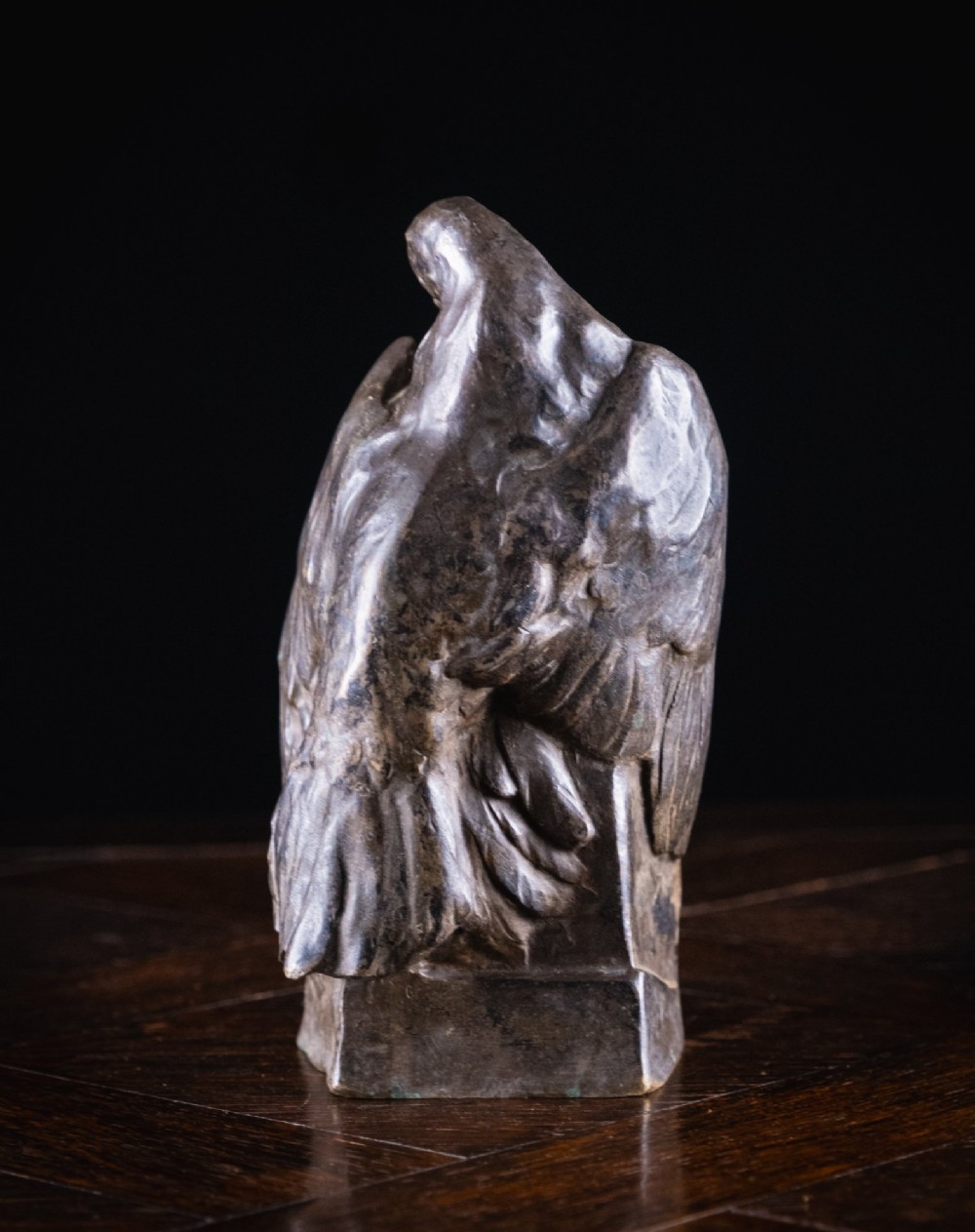 A dark nickel bronze sculpture depicting two stylised pigeons resting together on an integrated rectangular base. View VI