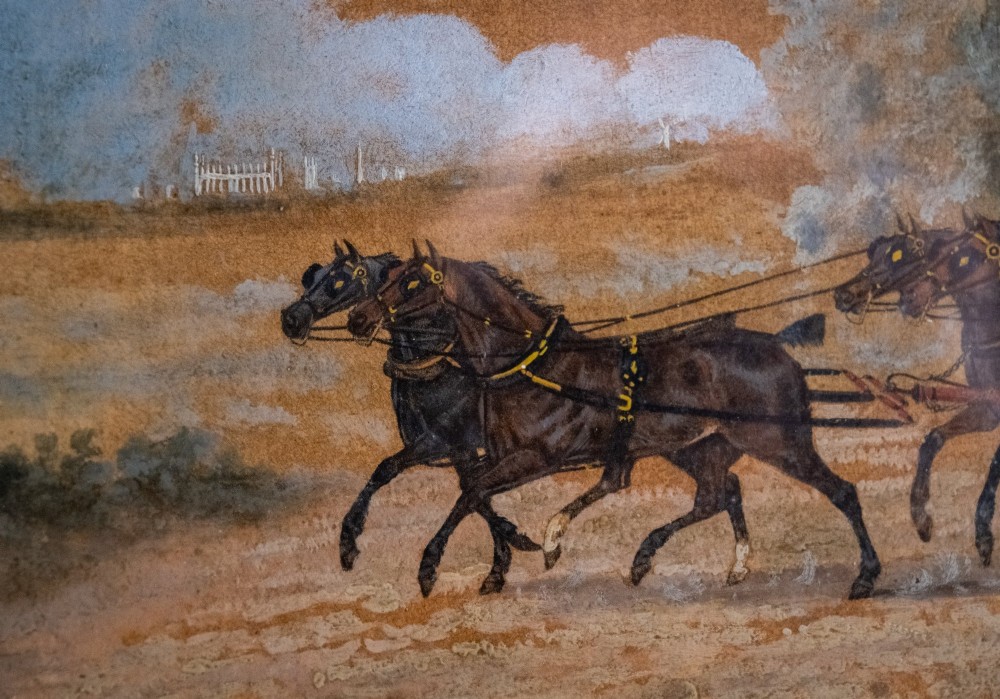A framed 19th-century oil painting on board depicting a horse-drawn stagecoach travelling along a rural dirt road past figures and a cottage under a cloudy sky. View II