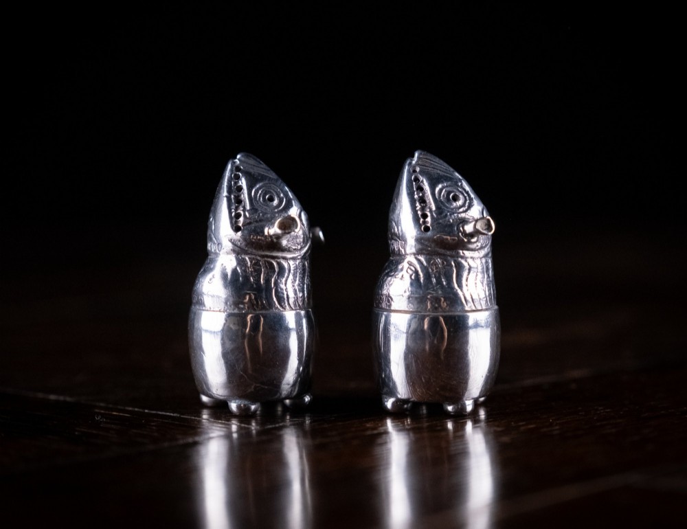A pair of Victorian sterling silver novelty pepper pots shaped as grotesque birds smoking pipes. View V