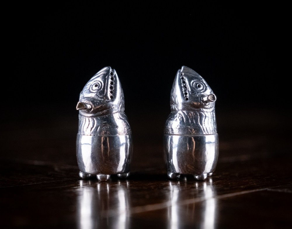 A pair of Victorian sterling silver novelty pepper pots shaped as grotesque birds smoking pipes. View VI