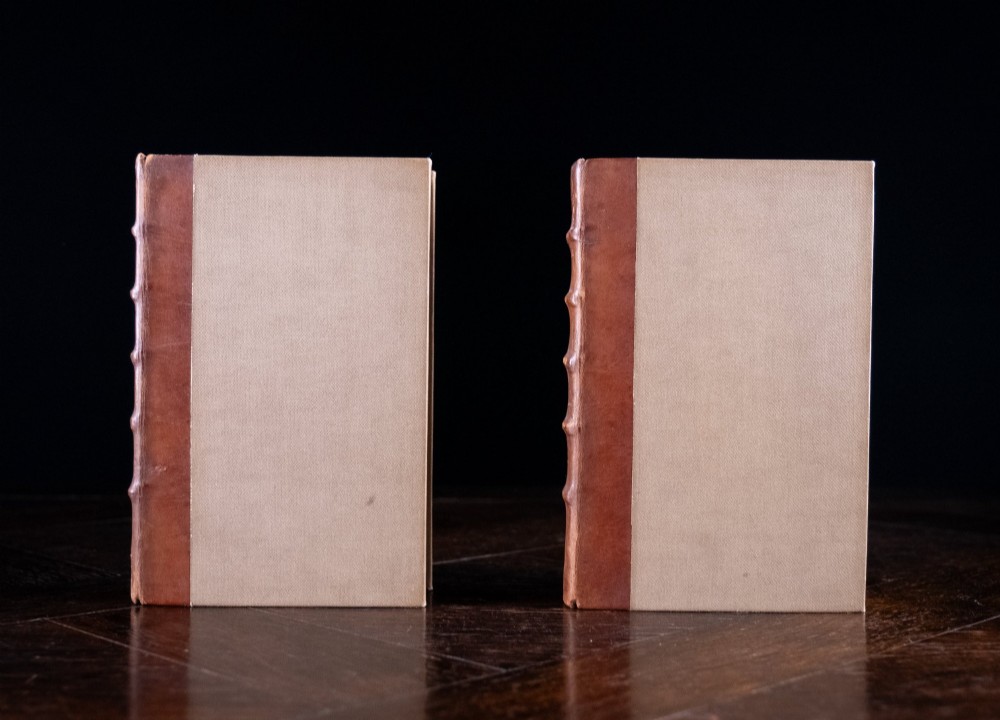 A two-volume set of 1899 first edition books titled The Life of William Morris, bound in brown leather spines with gilt lettering and cream cloth boards. View III