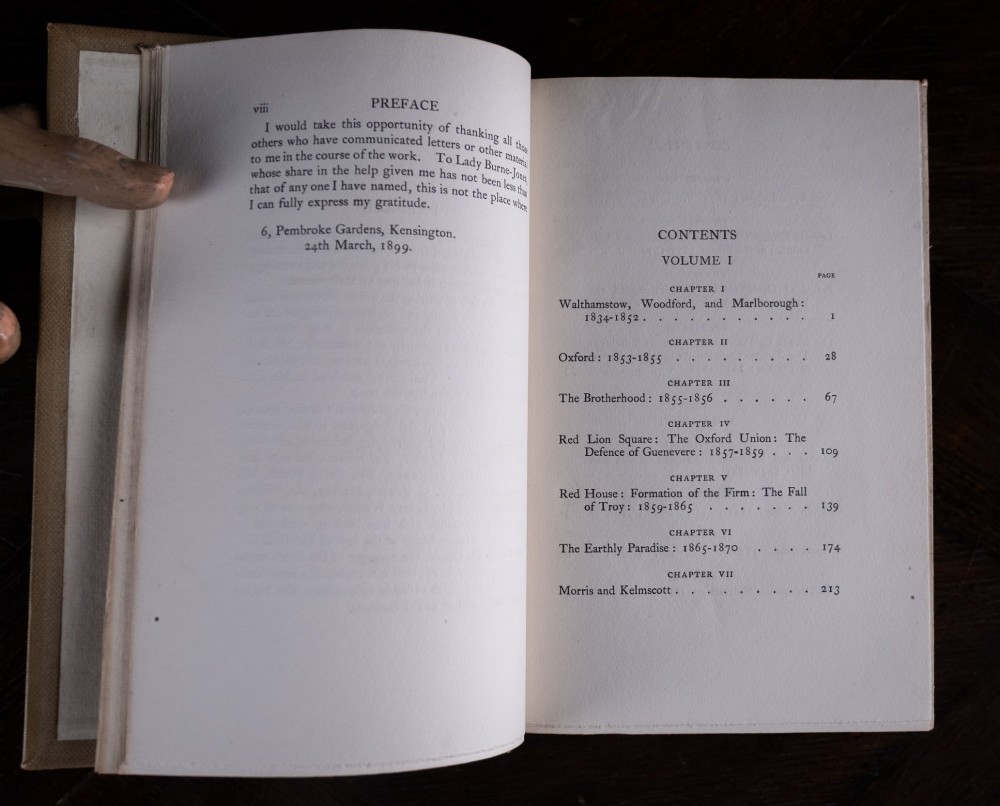 A two-volume set of 1899 first edition books titled The Life of William Morris, bound in brown leather spines with gilt lettering and cream cloth boards. View XI
