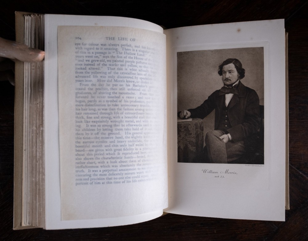 A two-volume set of 1899 first edition books titled The Life of William Morris, bound in brown leather spines with gilt lettering and cream cloth boards. View XII