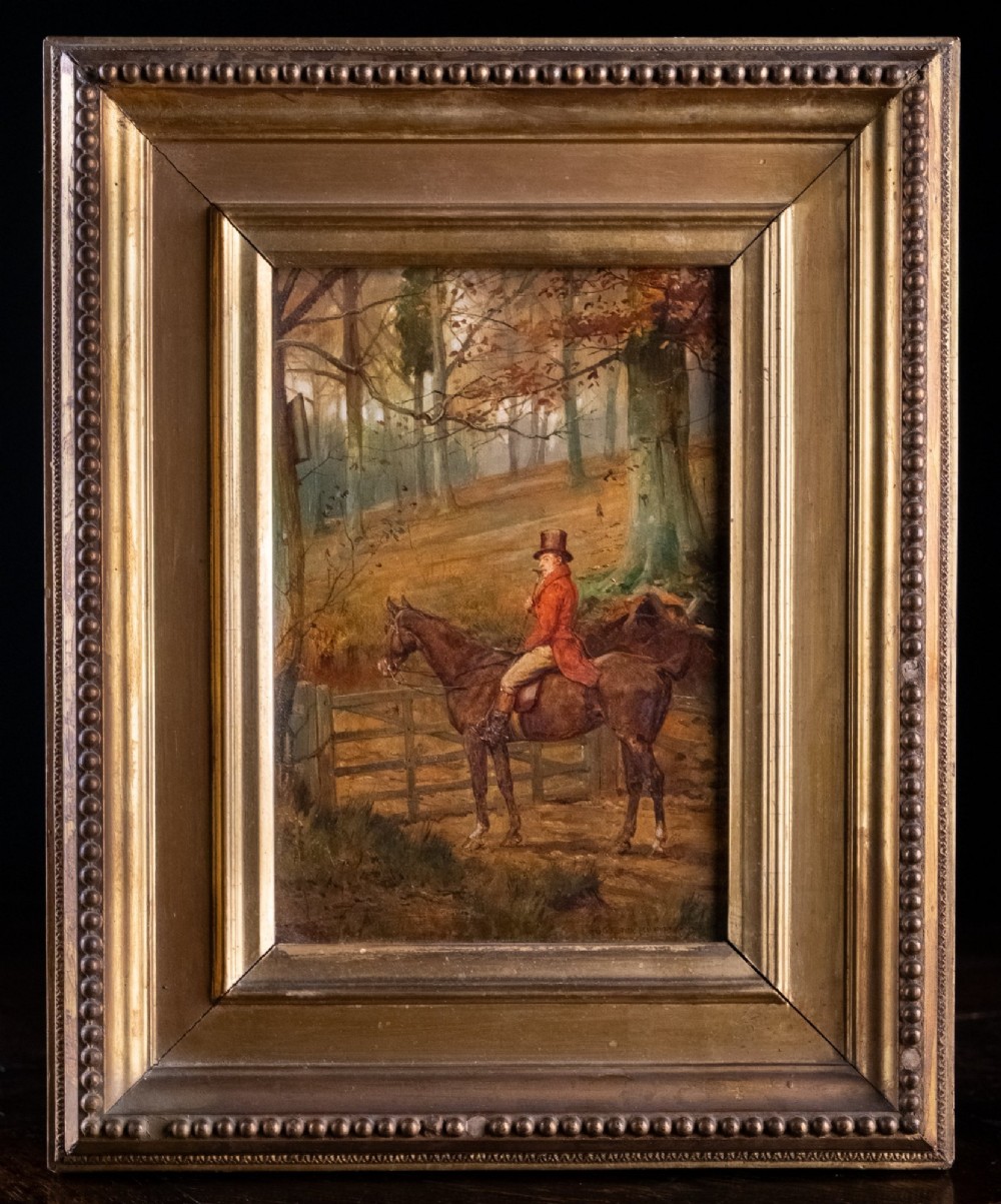 A 19th-century oil painting on panel depicting a gentleman in a red hunting coat atop a horse next to a timber gate in autumn woods. View IV