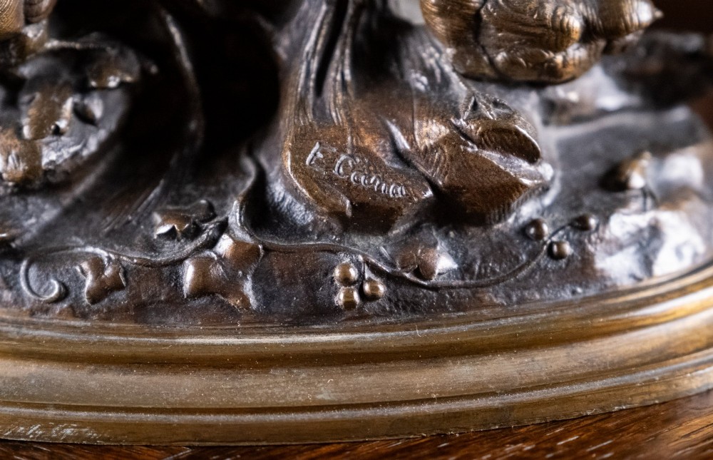 A 19th-century dark patinated bronze sculpture depicting parent birds and fledglings surrounding a foliage nest on an oval base. View VI