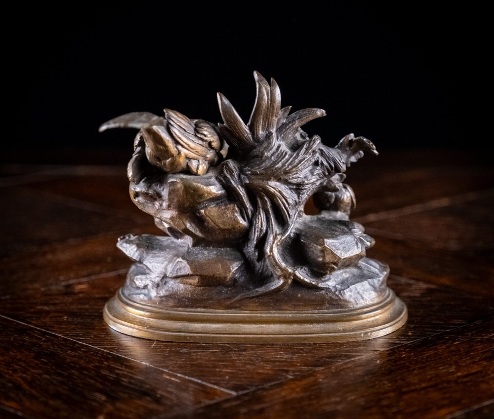 A 19th-century dark patinated bronze sculpture depicting parent birds and fledglings surrounding a foliage nest on an oval base. View VII