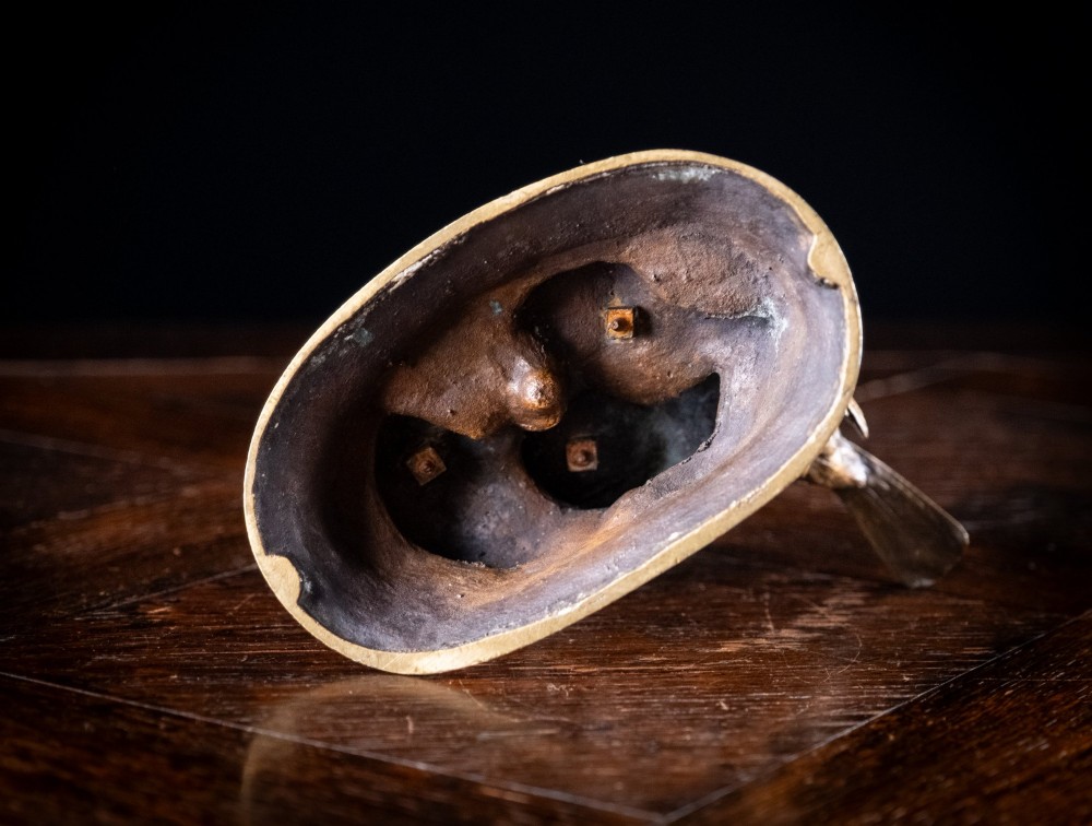 A 19th-century dark patinated bronze sculpture depicting parent birds and fledglings surrounding a foliage nest on an oval base. View IX