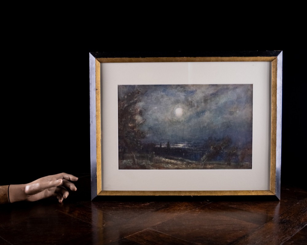 An antique watercolour painting depicting a bright full moon shining through cloudy night skies over a dark coastal landscape with silhouettes of trees. View VII