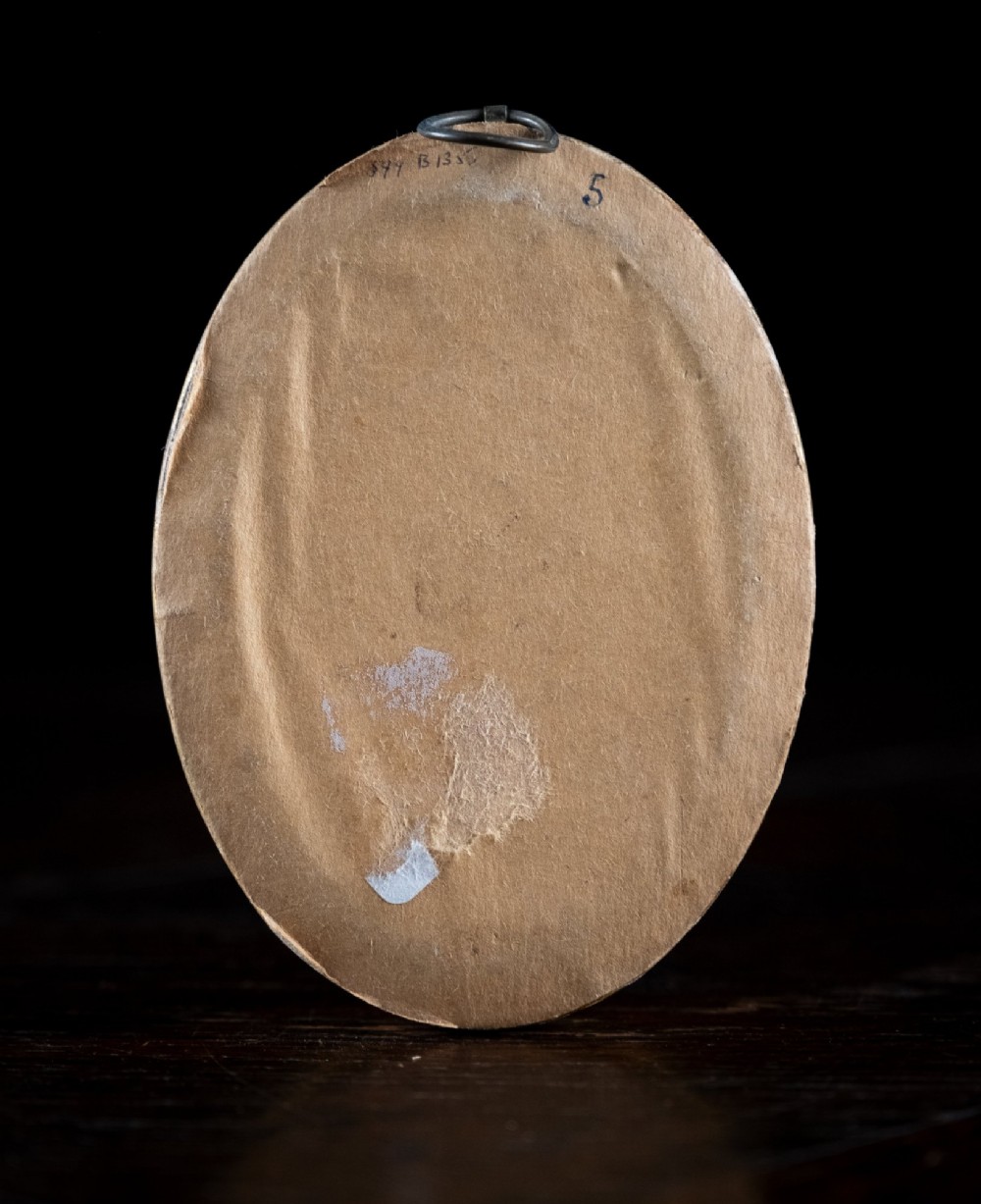 An oval framed Regency-era miniature silhouette depicting the profile of a lady embellished with fine gold detailing, set within a beaded gilt frame. View VIII