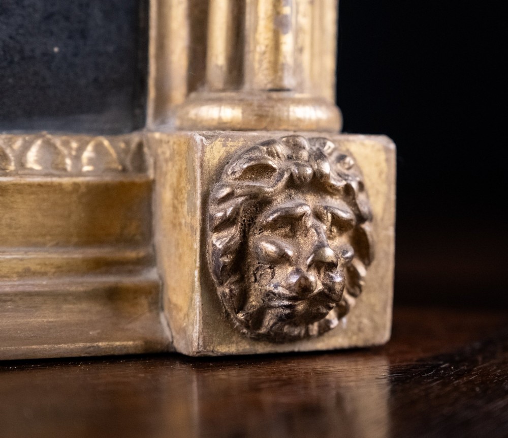 A large Regency style painted and gilded pier mirror featuring classical fluted columns, lion mask corner accents, a ball-ornament cornice, and distressed mirror glass. View VIII