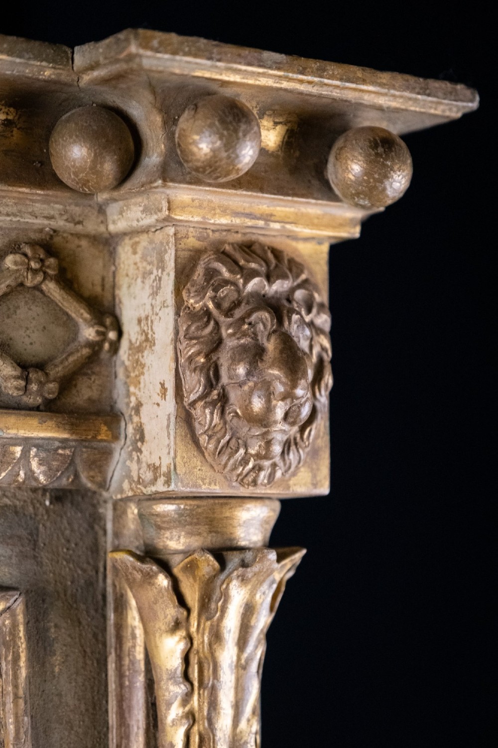A large Regency style painted and gilded pier mirror featuring classical fluted columns, lion mask corner accents, a ball-ornament cornice, and distressed mirror glass. View XI