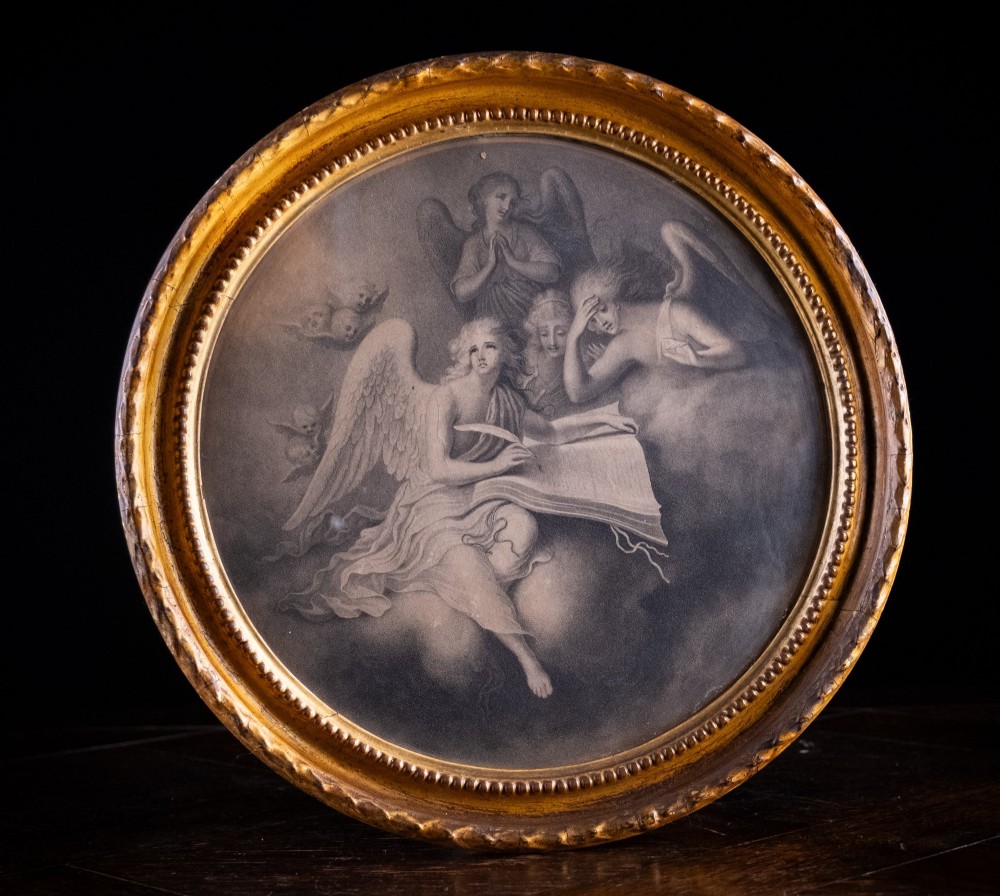 An eighteenth-century circular monochrome engraving depicting winged angels among clouds, set within a carved circular giltwood frame.
