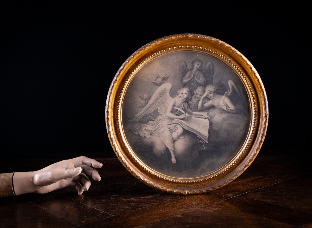 An eighteenth-century circular monochrome engraving depicting winged angels among clouds, set within a carved circular giltwood frame. View II