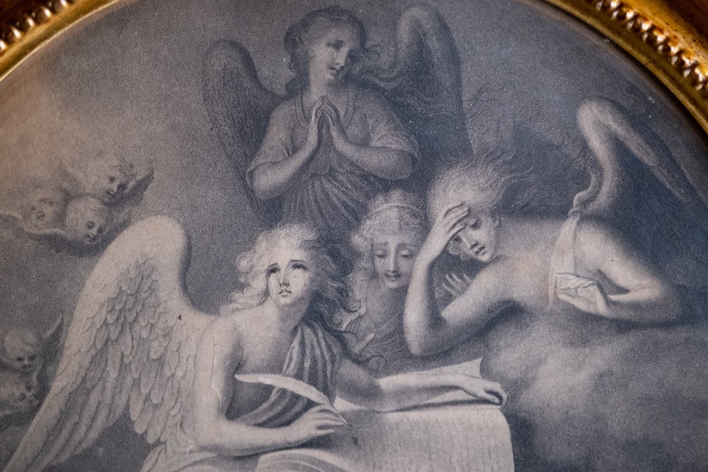 An eighteenth-century circular monochrome engraving depicting winged angels among clouds, set within a carved circular giltwood frame. View IV
