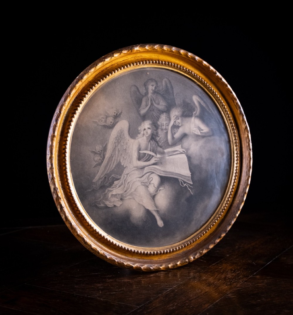 An eighteenth-century circular monochrome engraving depicting winged angels among clouds, set within a carved circular giltwood frame. View VI